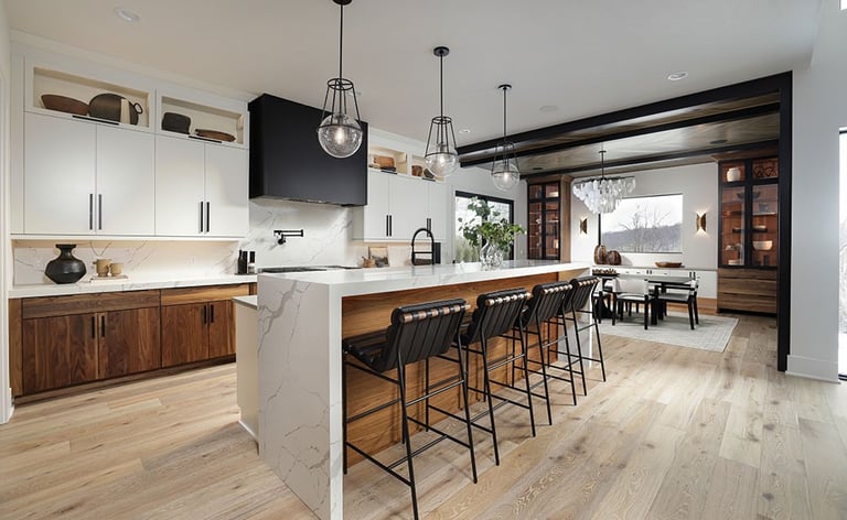 a kitchen with a large island and a bar stool
