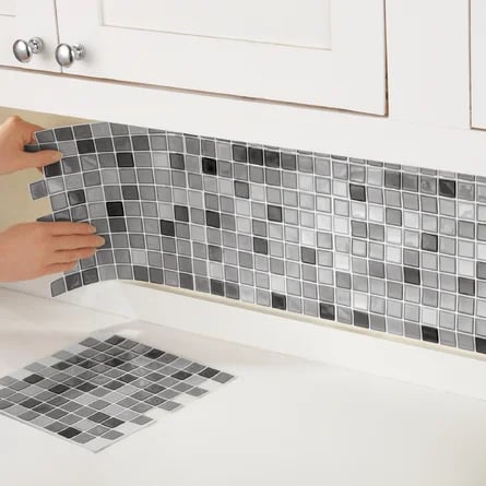 a person is cleaning a kitchen counter top