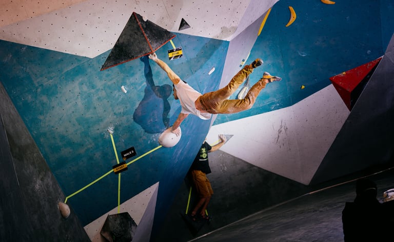 a man is bouldering on a climbing wall