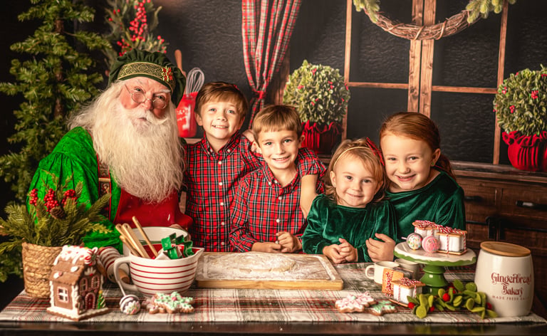 Santa Claus baking gingerbread cookies with four smiling children in a festive Christmas kitchen setting.