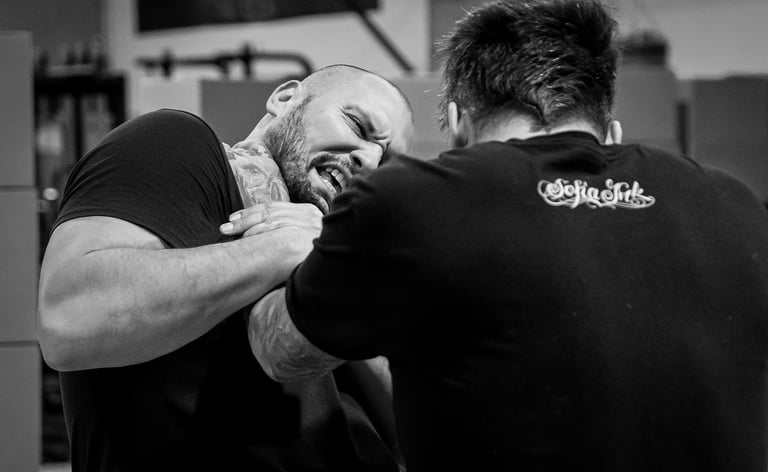 Two stuntmen grappling with one holding the other by the throat
