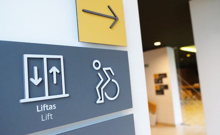 A sign that says "lift" and " way to the right for people with disabilities.