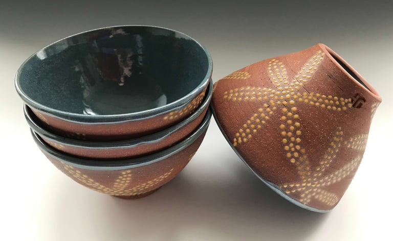 Ice cream bowls in red stoneware, glazed on inside, dotted on outside