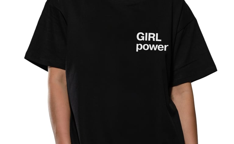 Woman wearing a black cotton t-shirt featuring a white Girl Power slogan on the chest.