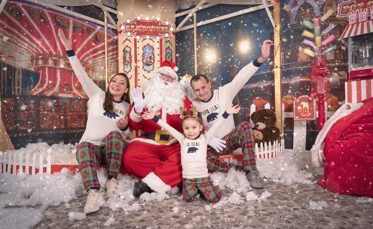 a family posing for a photo in front of a christmas tree