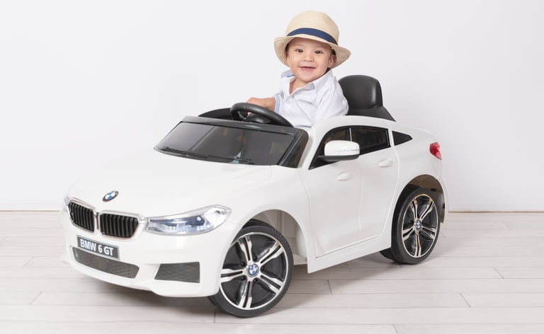 a little boy in a white shirt and hat