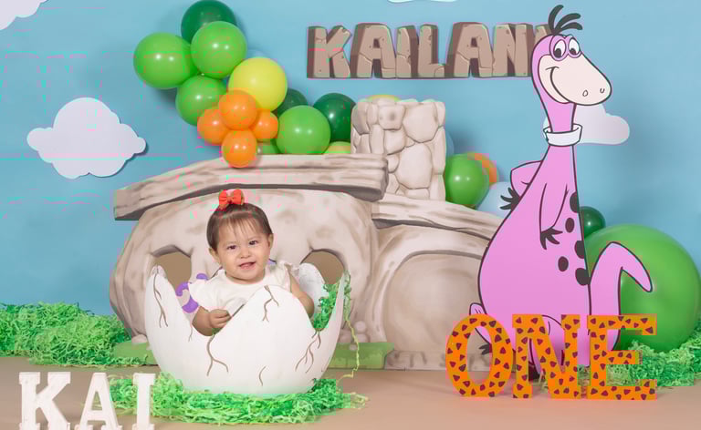 a baby in a dinosaur costume sitting in a dinosaur costume