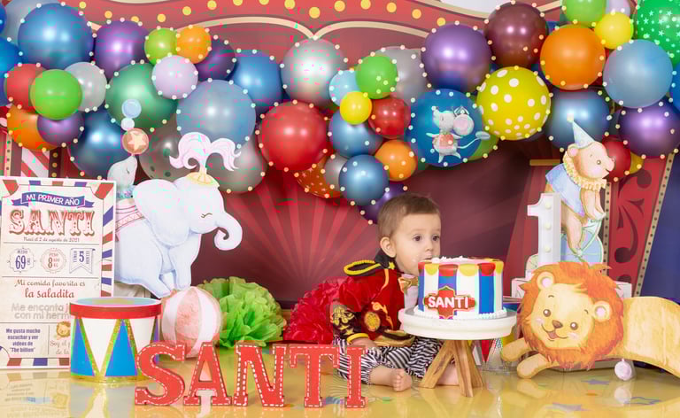 a baby boy in a circus themed birthday party