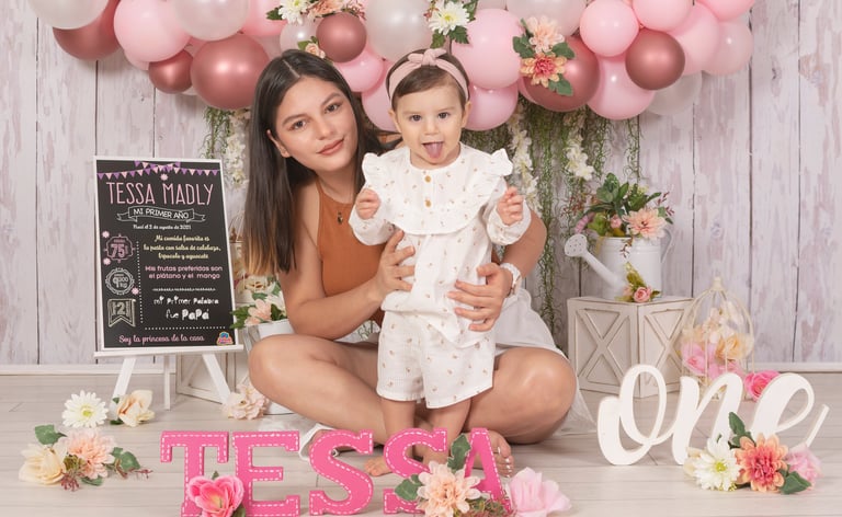 a man and woman with a baby in front of a cake