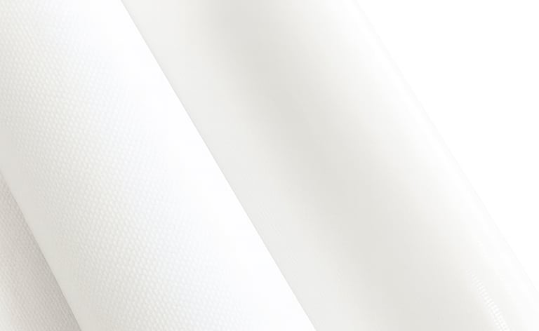Rolls of premium white canvas material showing fine woven texture for art printing.