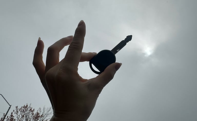 A hand holding a key up in the cloudy sky representing Jack’s Locksmith all keys lost trusted Weaverville, NC services