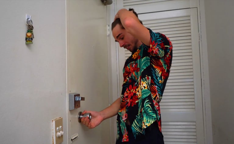 a man in a hawaiian shirt is holding a keychain
