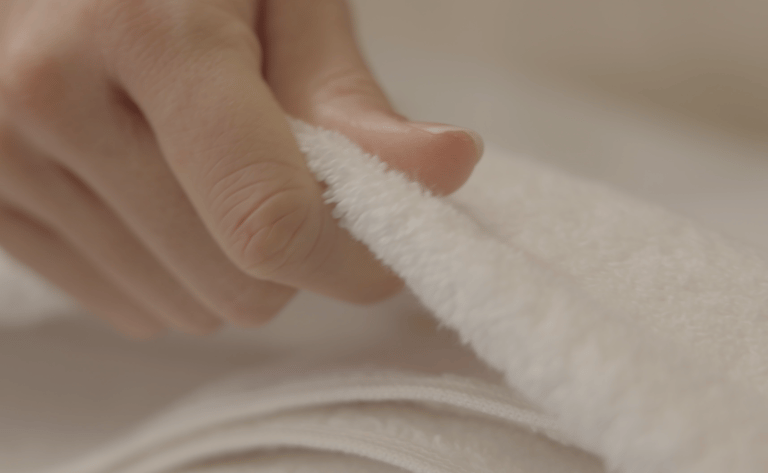 a person holding a towel over a towel