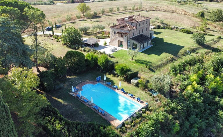 Aerial view of Villa Alta with a large swimming pool and lush green gardens.