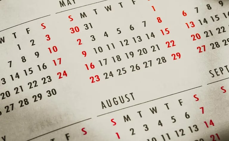 A close-up of an open paper calendar showing multiple months, ideal for planning, scheduling, and date tracking.