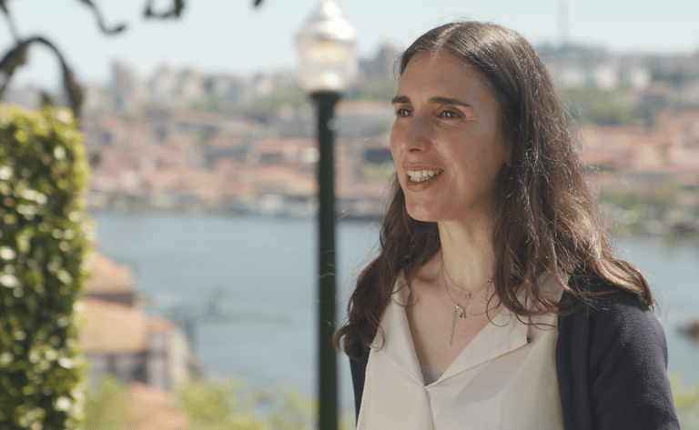 A woman, RIta Gomes, in a white shirt and a black jacket