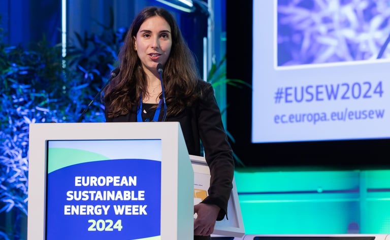 a woman in a black jacket speaking at the european sistainable energy week 2024