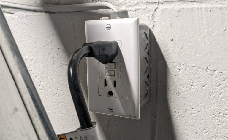 Black plug is connected to a GFCI protected outlet