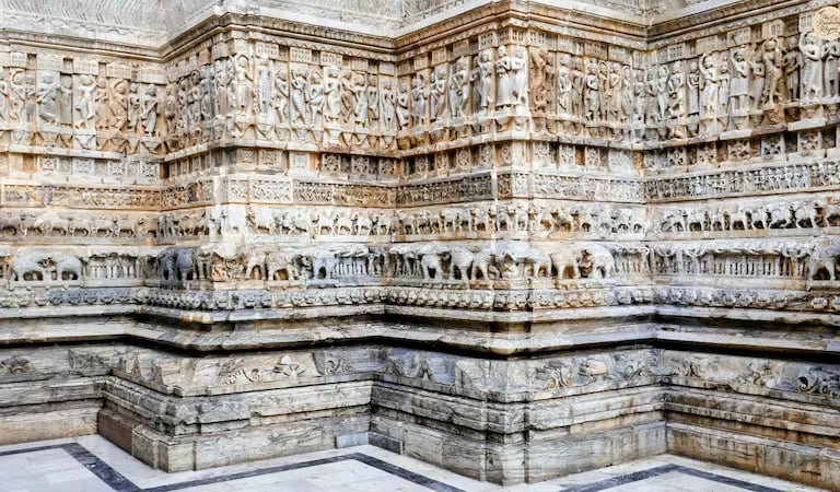 Intricate stone carvings at Jagdish Temple in Udaipur, showing detailed figures and mythological motifs.