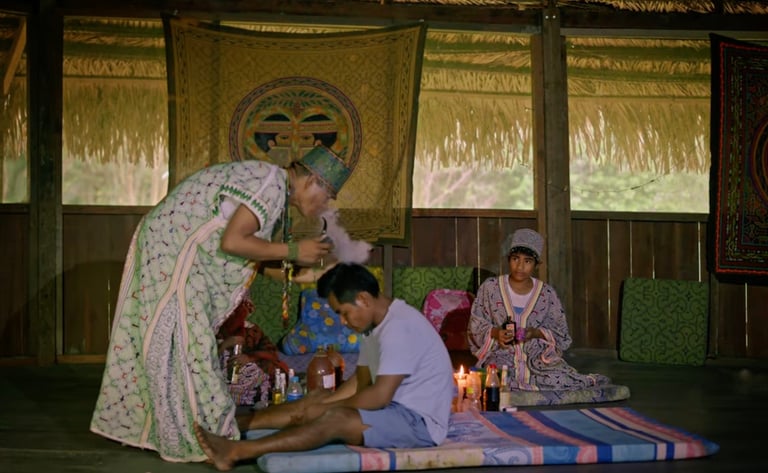 Roger Bardales performing a cleansing ceremony with Mapacho tobacco smoke in the Amazon rainforest.