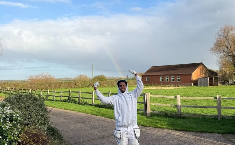 A staff member posing outside a property.