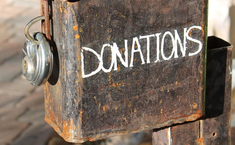 a rusty old metal box labeled donations