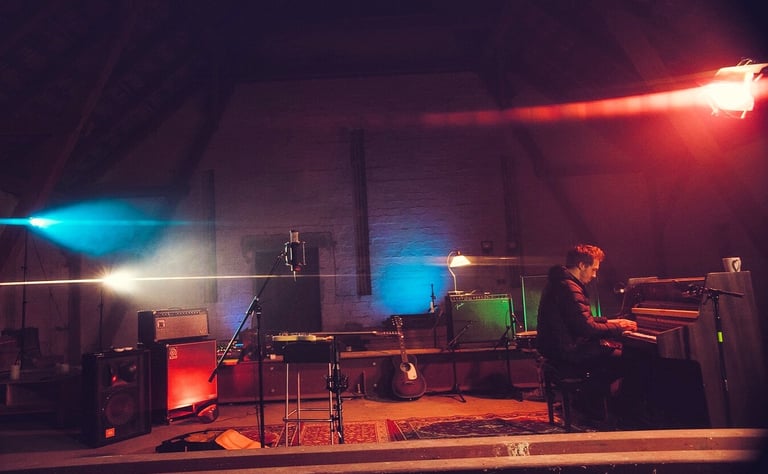 Live recording session with piano, amps and atmospheric lighting