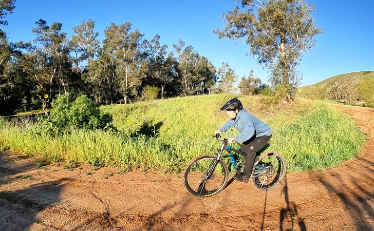 Mountain biker preloading before doing a J hop