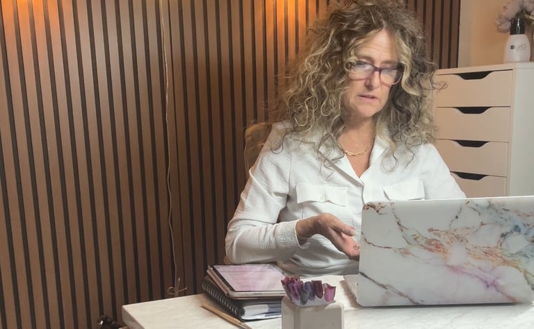 Exhausted nail technician at her station reflecting on nail tech burnout and underpricing