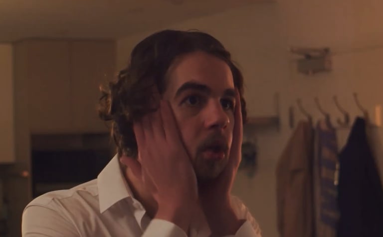 a man with a beard and a white shirt