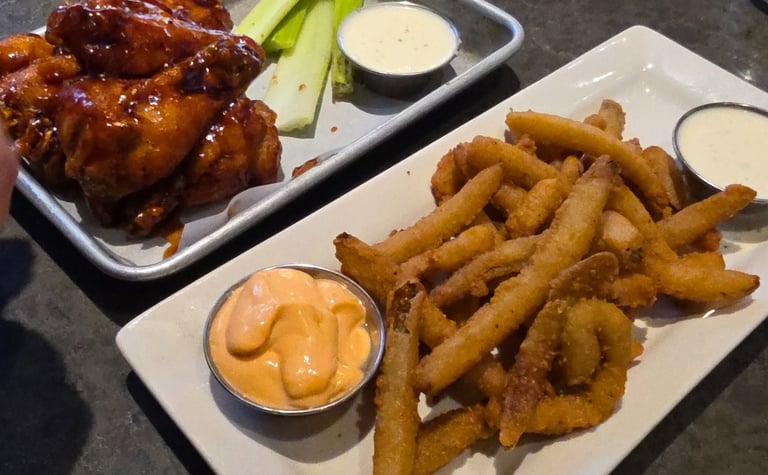 plate of Fryckle fries, ranch, barbeque wings, and celery