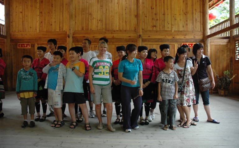 Tracey Billington with thetraditional long haired women at Huangluo Yao Village, China
