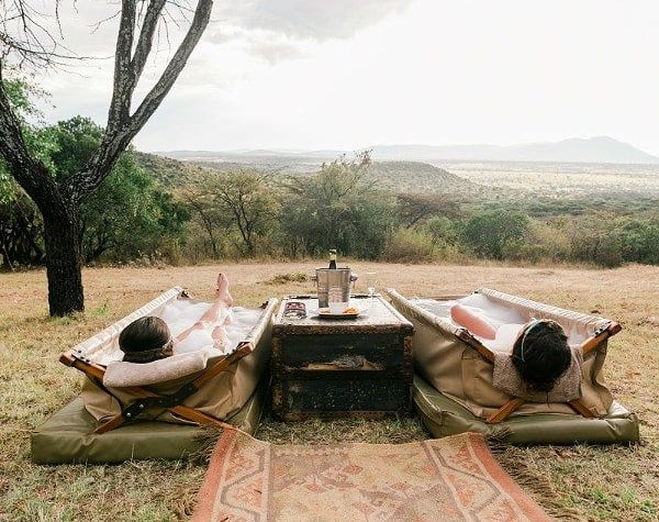 two people lying in an outdoor bath at a wellness safari in South Africa