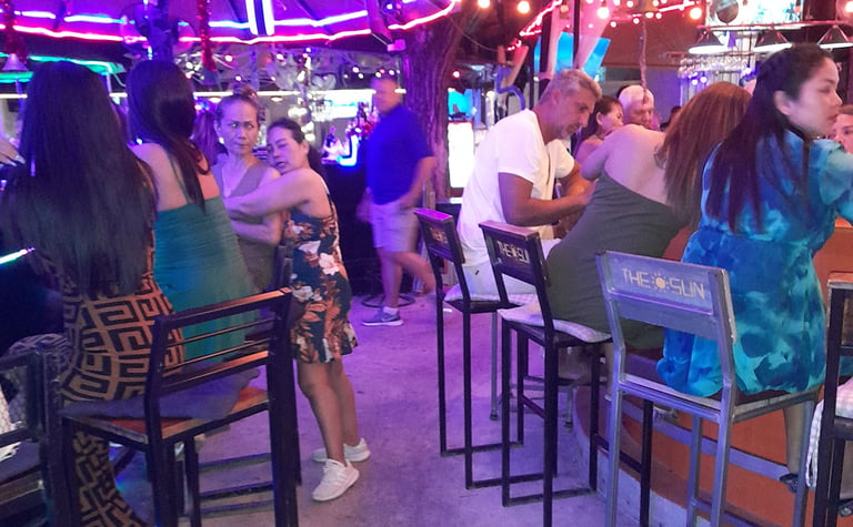 Thai women sat at bars in Wonderland bar complex, Hua Hin