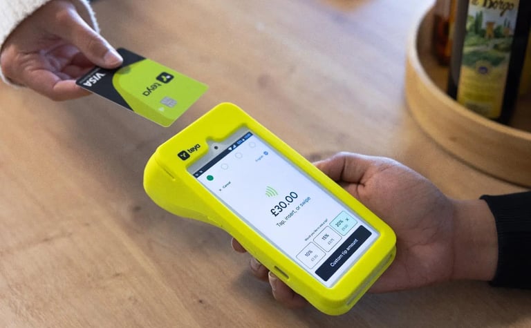 Customer using a contactless credit card for payment on a Teya mobile card machine terminal.