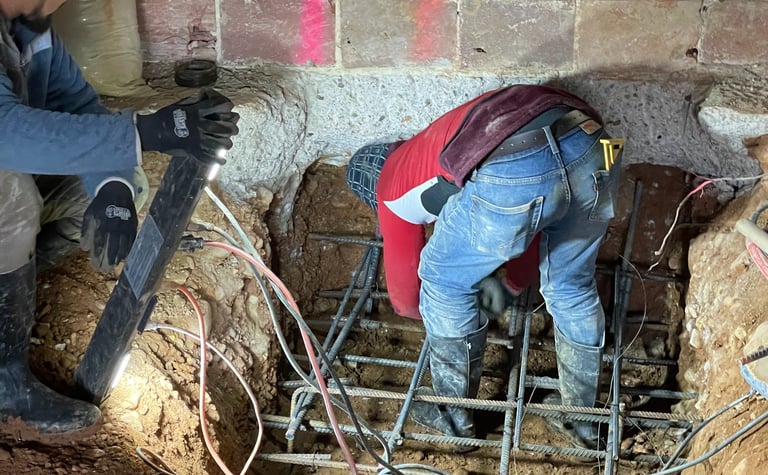 a man is working on a concrete floor