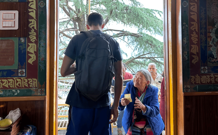An elderly lady asking for help from a young man. 