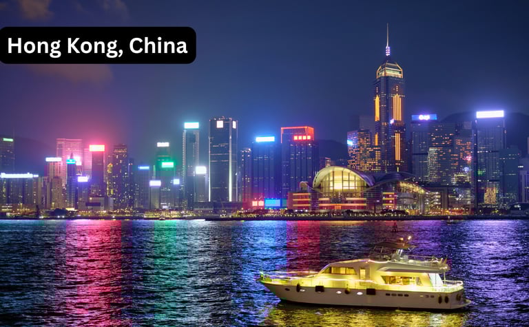 A breathtaking night view of the Hong Kong skyline across Victoria Harbour. The skyscrapers of Centr