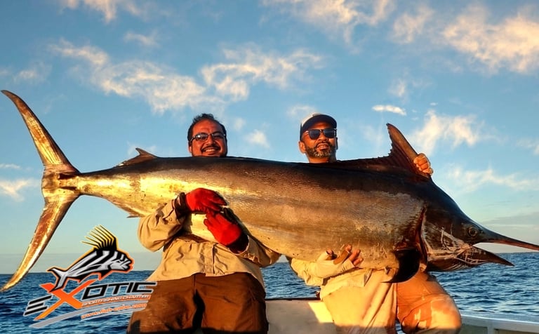 2 men holding a huge marlin fish