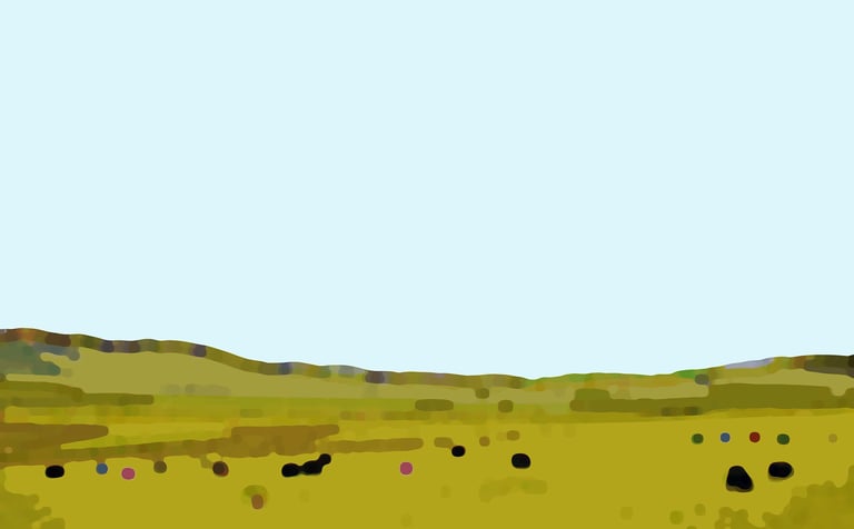 a field with a few cows grazing in the grass