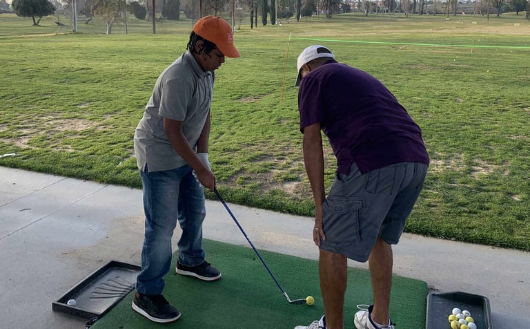 Enhancing Forward Action Inc. image young golfer being taught golf