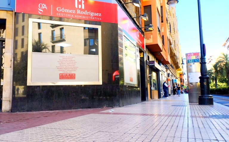 a person walking down a sidewalk with a sign that says goers are not allowed