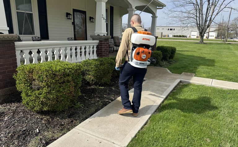 Pest control technician servicing for mosquitoes and ticks
