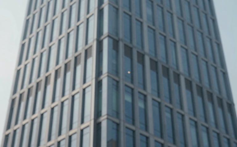 Abstract architectural shot of a modern skyscraper's steel and glass facade, symbolizing organizational structure and efficiency. Clean lines, sophisticated lighting, emphasizing #778DA9 and #1B263B tones.