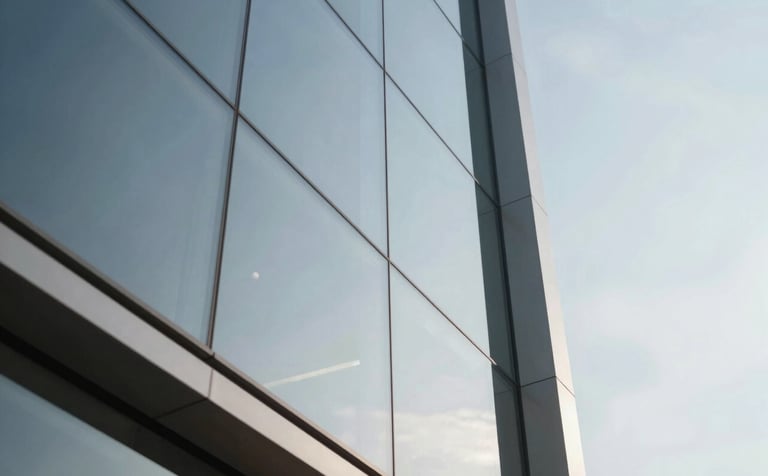 Abstract composition of glass and steel from a low angle, reflecting a clear, structured sky. Minimalist and corporate luxury aesthetic. Incorporates clean white and industrial gray tones with a hint of bronze in reflections.