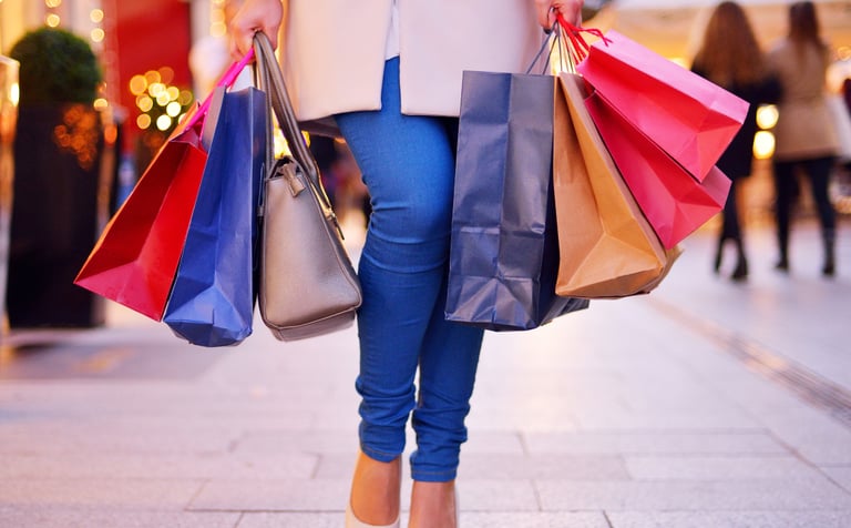 Woman with shopping bags walking down the street to symbolise AI in retail