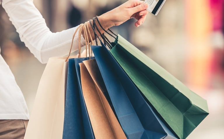 Woman with shopping bags and credit card to symbolise AI in retail