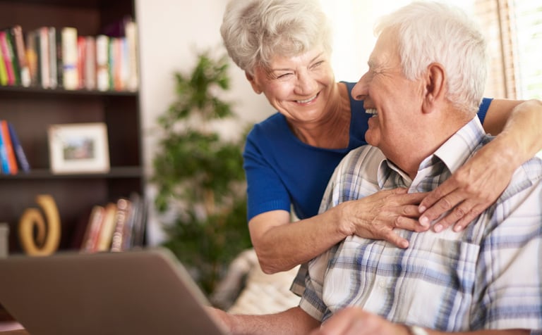 a man and woman sitting on a couch in a living room