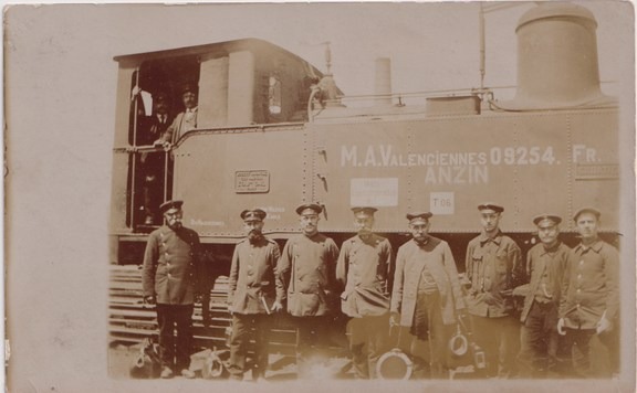 Photograph of German railwaymen in front of a locomotive at Valenciennes station in 1915.