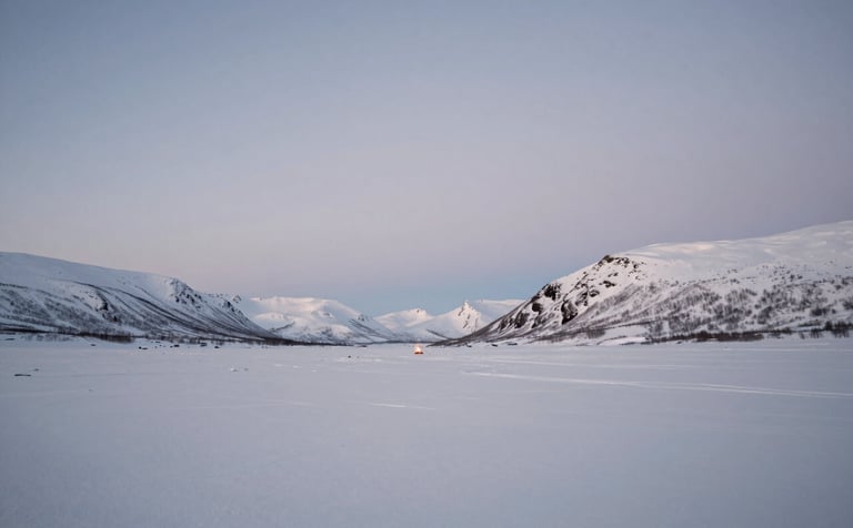 A wide, calming landscape of a snow-covered valley in the Arctic Circle under a soft blue twilight. A single small campfire glow is visible in the distance. The composition is minimalist and vast, emphasizing the quiet power of winter. Soft contrasts with colors #5E4B3E and #F4F0E4.
